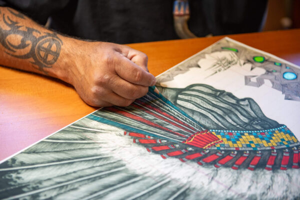 Evans Flammond Sr. (Oglala Sioux, Rosebud Sioux) | works on artwork at Yellowstone Tribal Heritage Center.